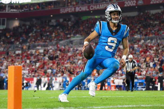 Bryce Young runs with the ball in one hand